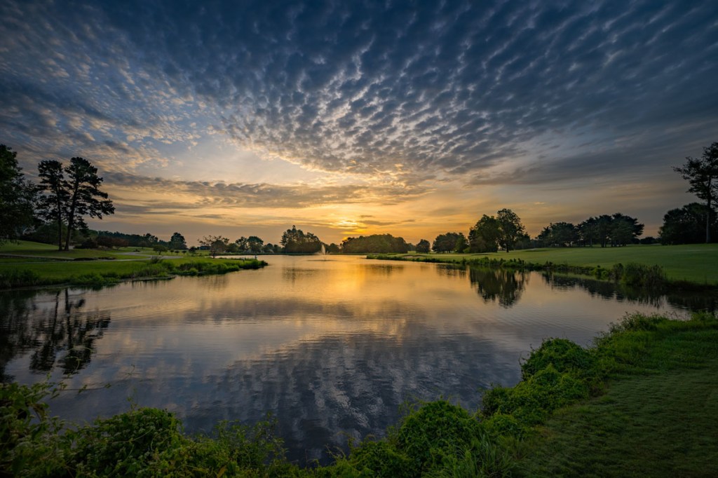 Couse greens with clouds hanging above 