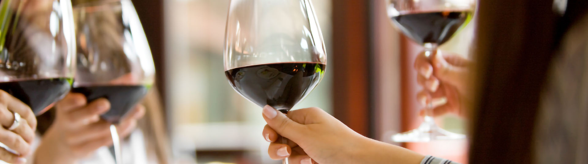 Close up of guest making cheers with red wine